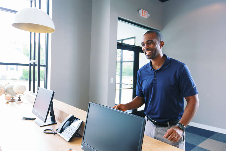 adult man standing checking in at dentist appointment